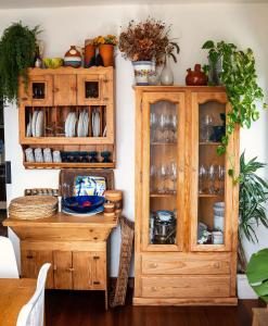 a wooden cabinet and a table in a room at Villa Pepe, casa compartida in Pontevedra +25 photos