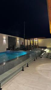 a swimming pool at night in a building at كوخ بحانز الأول in Taif