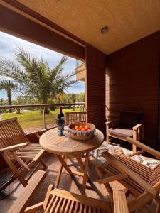 a patio with a table with a bowl of oranges on it at Luxury Dreamland Oasis Apartments in Chakvi