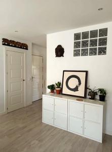 a room with white walls and white cabinets and potted plants at Ideal Familias, Prime, Netflix y Hbo in Aranjuez