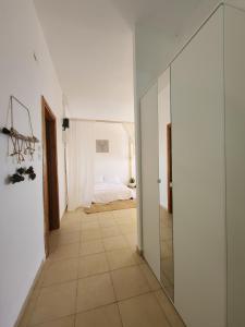 a hallway with a glass door and a bedroom at קצה ההר in Amirim +16 photos