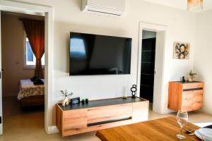 a living room with a large flat screen tv on a wall at Luxury Apartment Mara in Sukošan