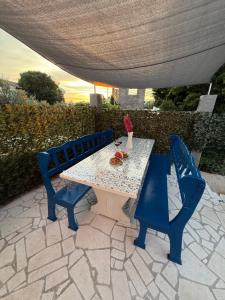 a table and two chairs sitting under a umbrella at Villa Adria in Novalja