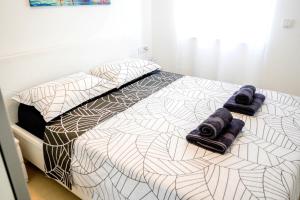 a bedroom with a bed with towels on it at Luxury Apartment Mara in Sukošan