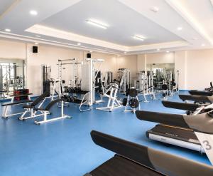 a gym with several treadmills and machines in it at Villa Aglou Center in Zaouia Sidi Ouaggag