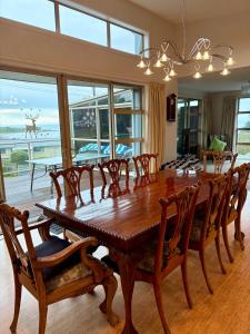 a dining room with a wooden table and chairs at Ocean view on Semple in Kakanui