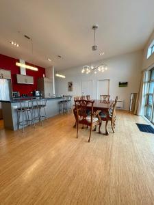a room with a table and chairs and a kitchen at Ocean view on Semple in Kakanui