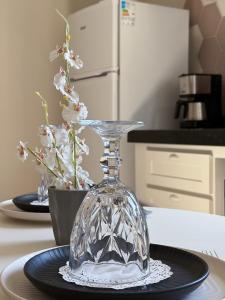 a glass vase sitting on top of a table at My Way Flat in Aracati
