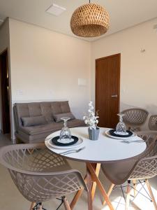 a living room with a white table and chairs at My Way Flat in Aracati