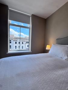 a bedroom with a bed and a large window at Studio 4 in Portadown