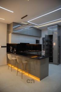 a kitchen with a counter and stools in a room at Villa BOCANIA in Cotonou