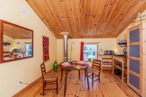 a kitchen and dining room with a table and chairs at Spa Stukely in Eastman