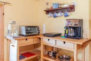 a kitchen with a counter with a toaster and a microwave at Spa Stukely in Eastman