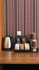 a counter top with a coffee pot and some candles at WADI RUM NASA lUXURY BUBBLE in Wadi Rum