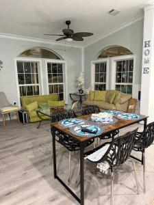 a living room with a table and chairs at Tami Beach Resort Rental in Fort Myers Beach