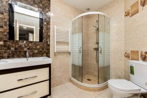 a bathroom with a shower and a toilet and a sink at Columna Residence in Chişinău