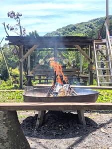 a fire pit with flames in it at Farm Garden Hotel in Numazu