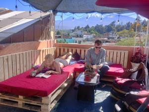 a man and a child sitting on beds on a balcony at Il Riposo in Arequipa