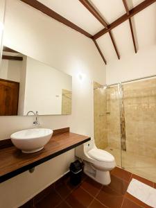 a bathroom with a sink and a toilet and a shower at Yeshca Hotel Boutique in Villa de Leyva
