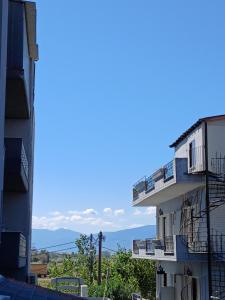 an apartment building with balconies on the side of it at Lana in Paralia Katerinis
