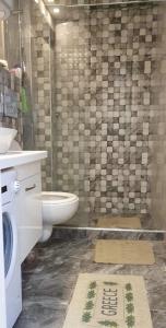 a bathroom with a toilet and a sink and a shower at Lana in Paralia Katerinis