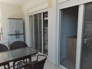 a dining room with a table and chairs and a sliding glass door at Lana in Paralia Katerinis