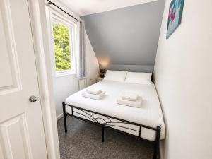 a small bed in a small room with a window at 47 Trevithick Court in Hayle +5 photos