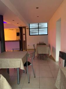a dining room with tables and chairs and a window at Casa UNO in San Rafael