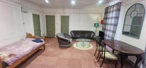 a living room with a bed and a table and chairs at King Suite in Ipswich