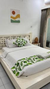 a large bed with a green and white blanket on it at Casavina residen kubu manyar 202 in Dalung +65 photos