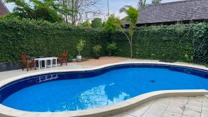 a large blue swimming pool with a table and chairs at Casavina residen kubu manyar 202 in Dalung