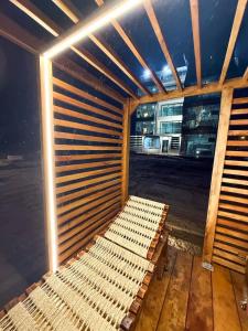 a wooden bench in a room with a window at Beachfront Escape Pool Hot Tub and Fire pit in Montañita