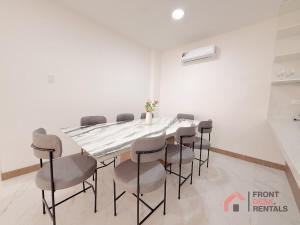 a dining room with a table and chairs at Beachfront Escape Pool Hot Tub and Fire pit in Montañita