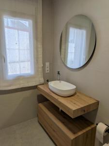 a bathroom with a white sink and a mirror at Jardín del Jiloca in Calamocha +12 photos