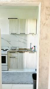 a white kitchen with a sink and a stove at Ulcinj apartments in Ulcinj