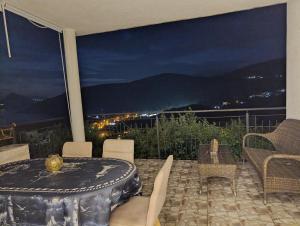 a table and chairs on a patio with a view at Lustica-Apartment Dora3 in Herceg-Novi