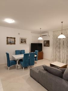 a living room with a couch and a table and chairs at Lustica-Apartment Dora3 in Herceg-Novi