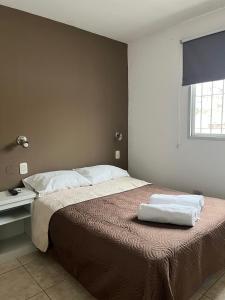 a bedroom with a bed with two towels on it at Casa UNO in San Rafael +8 photos