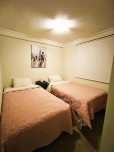 a room with two beds in a room at Departamento El refugio in Osorno