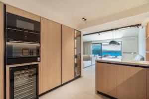 a kitchen with a stove top oven and a living room at Villa Incanto in Nydri