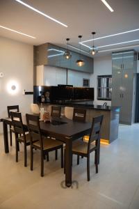 a kitchen and dining room with a table and chairs at Villa CICAS in Cotonou +8 photos
