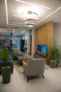 a living room with a couch and a tv at Villa CICAS in Cotonou