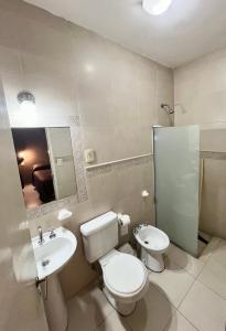 a bathroom with a toilet and a sink and a mirror at Casa UNO in San Rafael