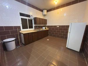 a kitchen with a white refrigerator in a room at مساكن المبيت 5 new in Abha +11 photos