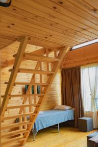 a room with a wooden staircase in a wooden house at Kazbegi 4 side cottages in Kazbegi