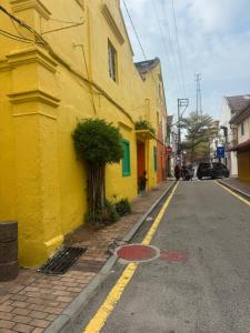 a yellow building on the side of a street at Nangyang lodge in Malacca
