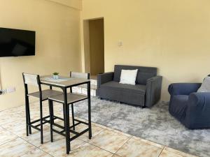 a living room with a table and a couch at Hibiscus Apt 1 in Corinthe