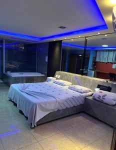 a bedroom with a large bed in a room at Motel Blue Star II in Campo Mourão
