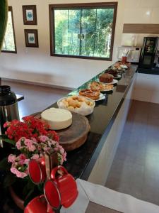 a buffet line with pies and pastries on it at Pousada Recanto do Sossego- Serra da Canastra in Vargem Bonita