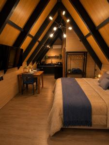 a bedroom with a large bed and a dining room at Cabana Do Luar in Serra Negra